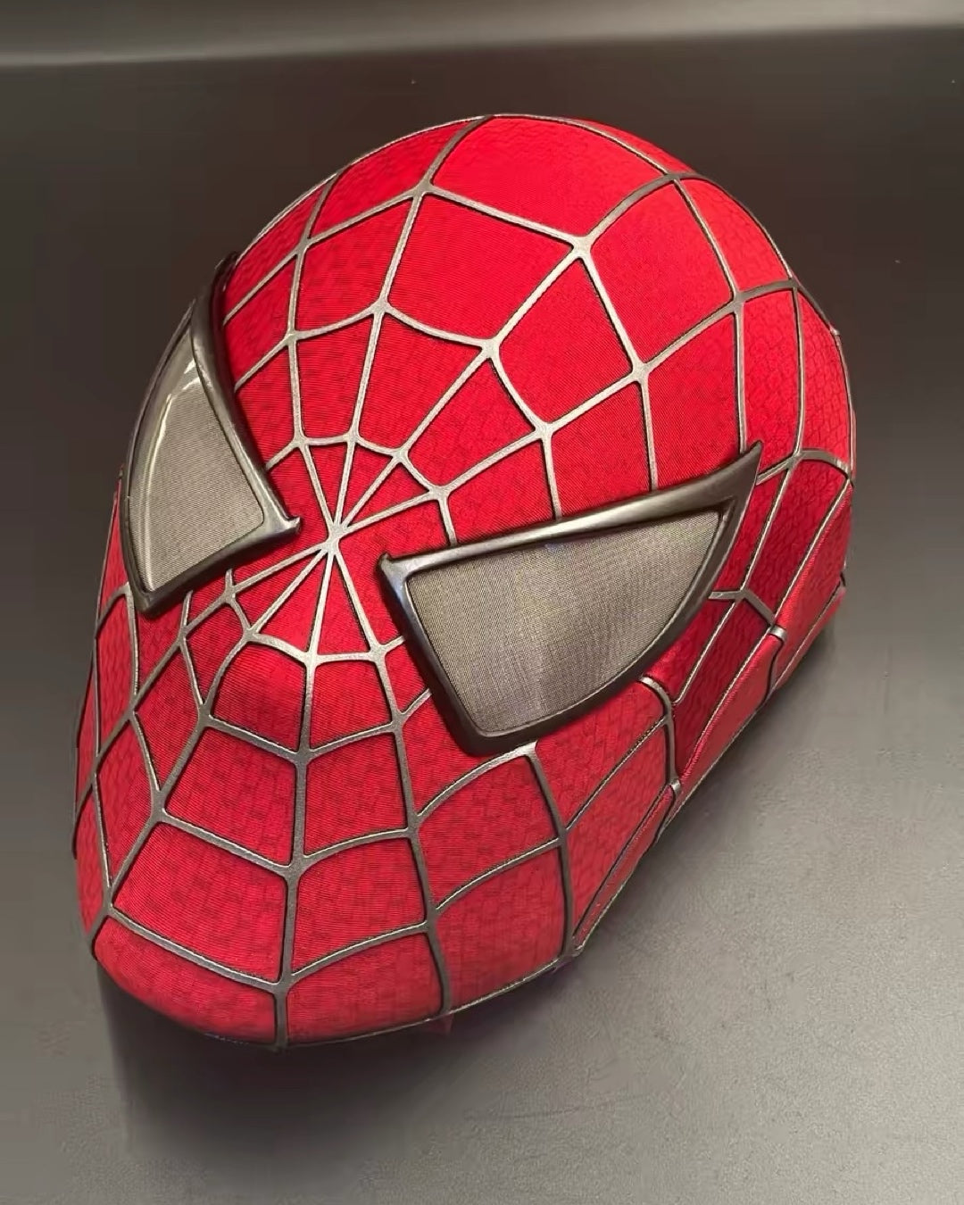 Spider-Man Tobey Mask with web pattern on a gray background